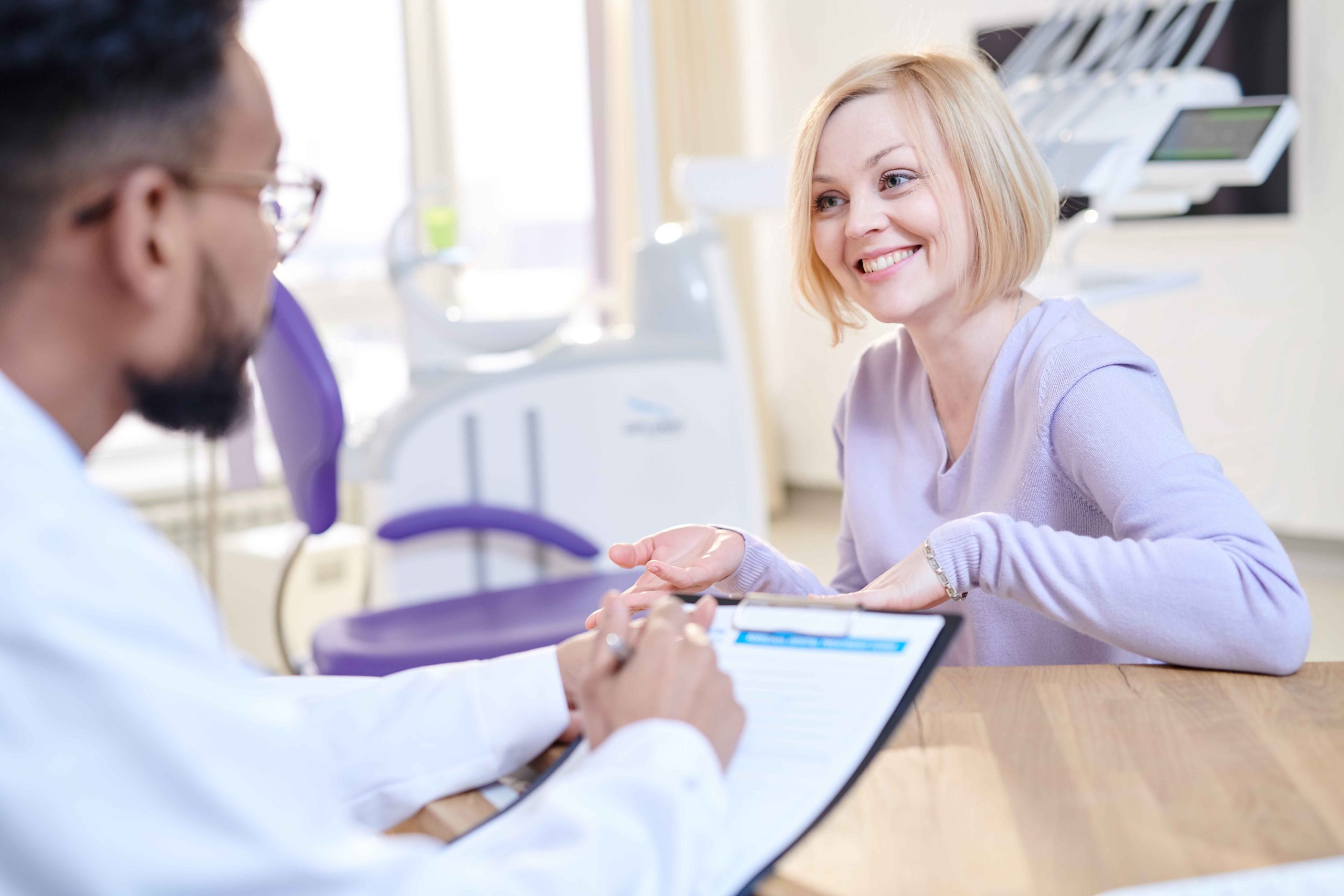 Smiling Young Woman Visiting Doctor
